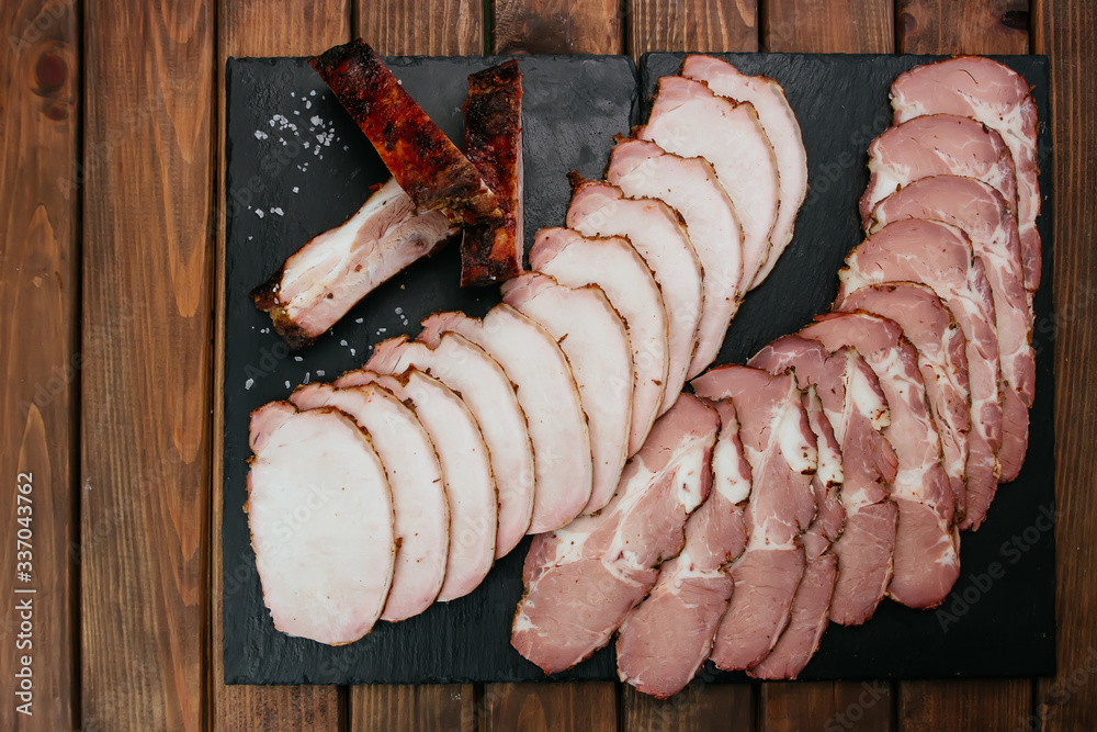 Φωτογραφία pork ribs grilled with BBQ and ham Tasty snack to beer for filing on dark concrete background