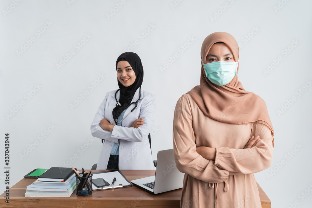 muslim patient during medical check up with doctor wearing masks
