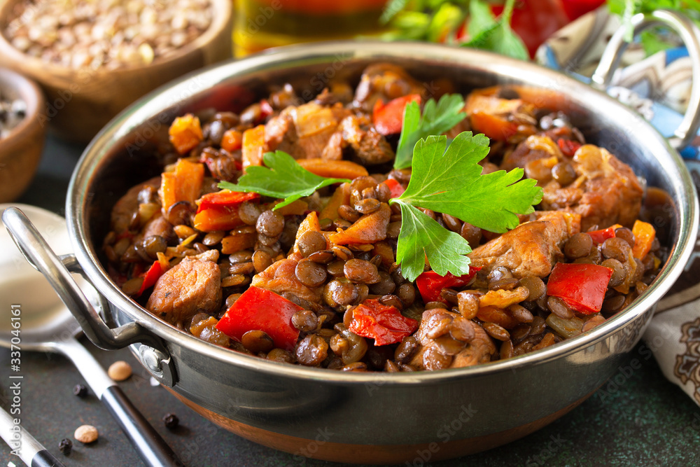 Indian food, authentic indian dish close-up. Traditional Indian spicy green lentils with meat, spices, herbs on a stone table.