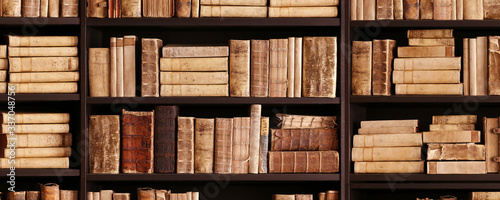 antique books on old wooden shelf.