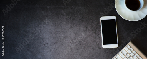 panoramic banner, top view workspace on dark gray background with copyspace at left 
