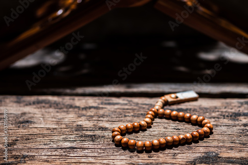 Islamic prayer beads that called as misbaha or tasbih on old rustic wooden plank in rural house. It is suitable for background of Ramadan-themed design concepts or other Islamic religious events.