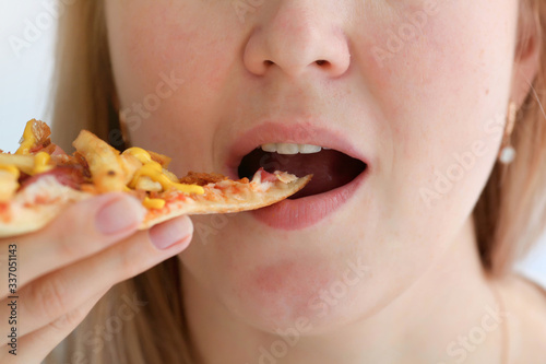 Woman eats with great pleasure  woman eats pizza  food.