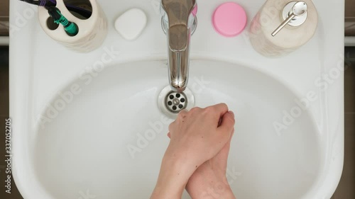 stop motion animation where women's hands on the background of the sink show how to wash their hands with liquid soap, take a toothbrush, tooth powder, dental floss after being wiped with a towel stop