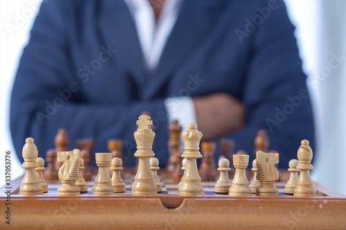 Businessman hand moving of playing chess strategy concept: symbol confident new strategy plan for win and success, sports game thinking battle planning object achievement queen for successful 