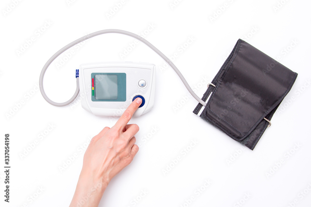 Electronic tonometer on the hand isolated on white Electronic tonometer on the hand isolated on white