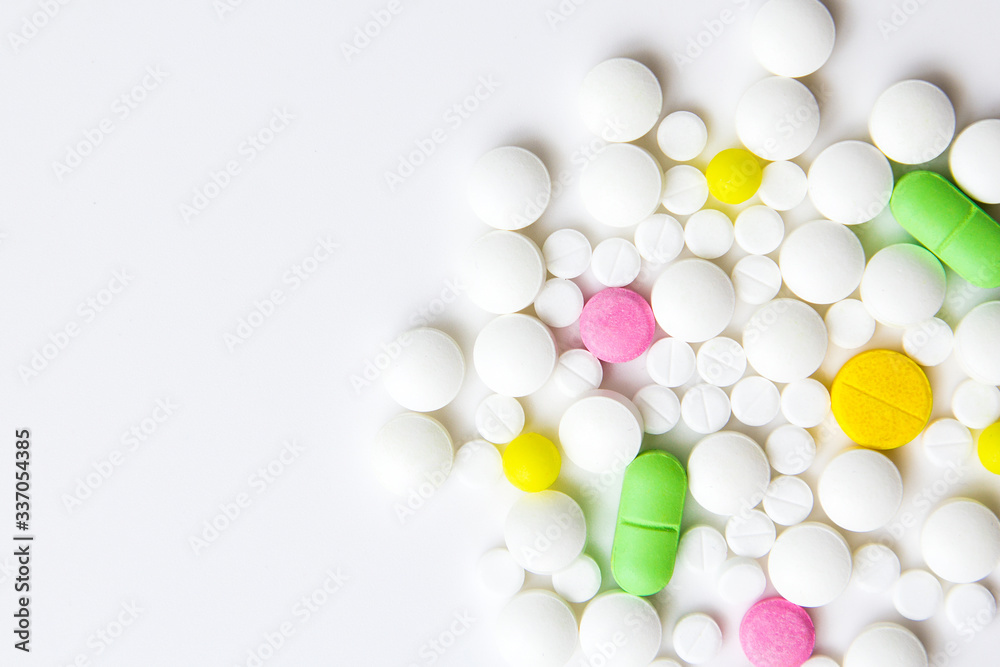 ndful of tablets and pills in hand isolated on white ndful of tablets and pills in hand isolated on white