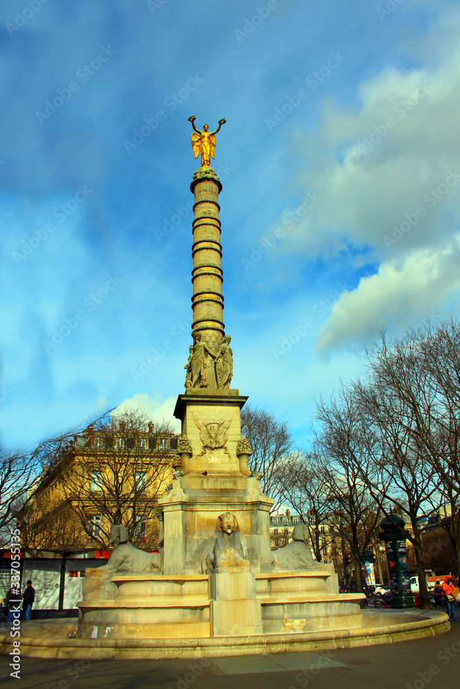  View from far distance of the monument column with Golden angel on top of stone sphinxes at the bottom 