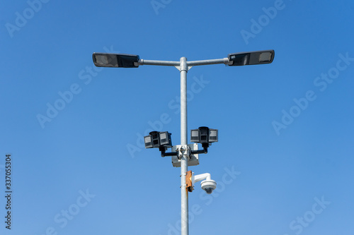 Automated car parking sensors on a lamp post in a car park