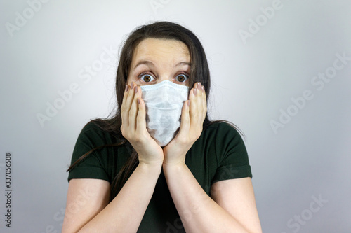 worried and fearful woman in medical mask - social distancing from corona virus covid-19 , surprised, amazed and cry