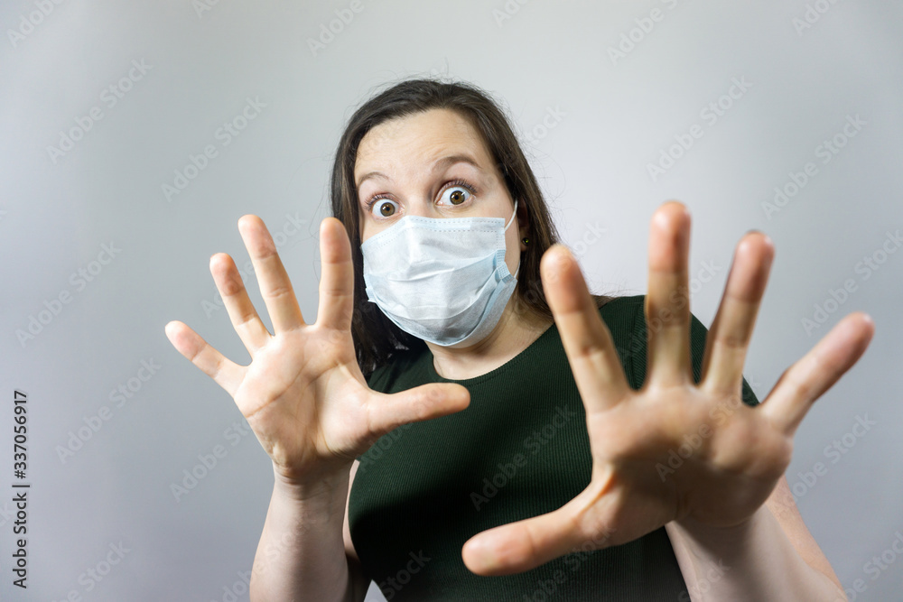worried and fearful woman in medical mask - social distancing from corona virus covid-19 , surprised, amazed and cry worried and fearful woman in medical mask - social distancing from corona virus covid-19 , surprised, amazed and cry