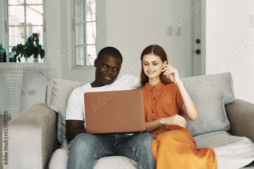 hispanic couple using laptop