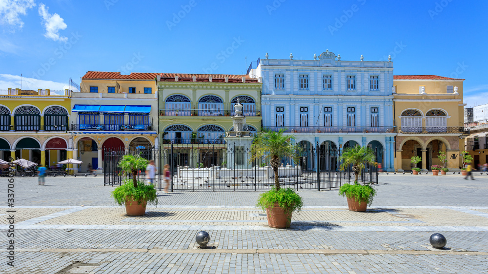 Havana Cuba View of Plaza Vieja colored houses with a sunny blue sky.