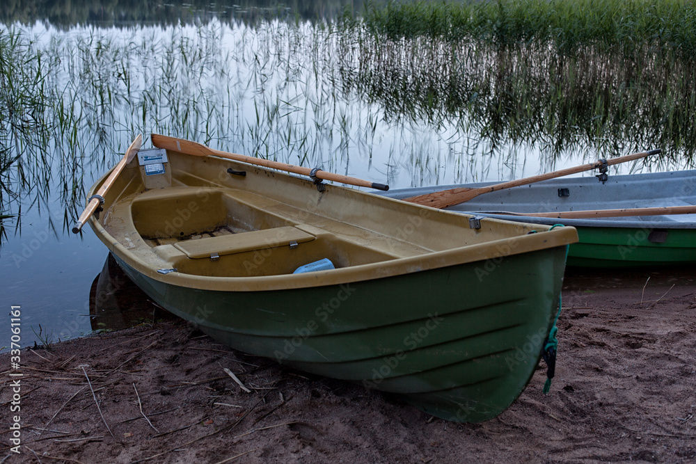 boat on the shore of a forest lake