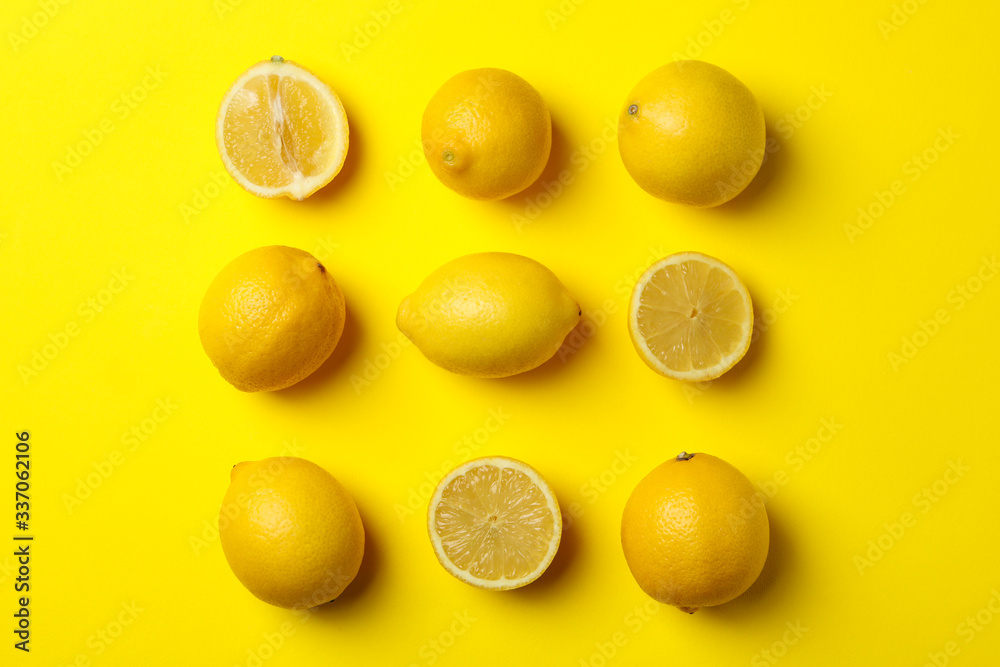 Flat lay composition with lemons on yellow background