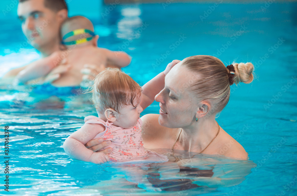 occupation in the pool of children with a swimming coach.