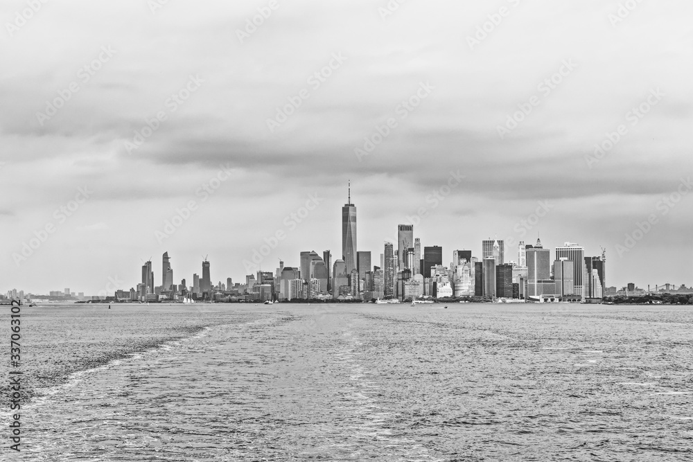 Dramatic Manhattan Island panorama during the gloomy weather from the Staten Island Ferry in New York.