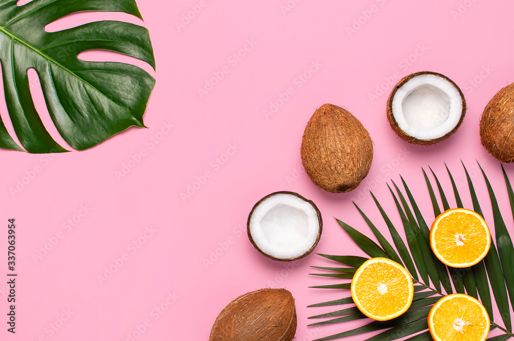 Summer tropical composition. Green tropical leaves of palm trees and monstera, coconut, orange on bright pink background. Flat lay, top view, copy space. Creative background food, fruit Summer tropical composition. Green tropical leaves of palm trees and monstera, coconut, orange on bright pink background. Flat lay, top view, copy space. Creative background food, fruit