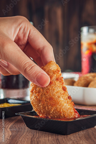 Brazilian appetizer deep fried beef croquette served with ketchup - Risolis de carne photo