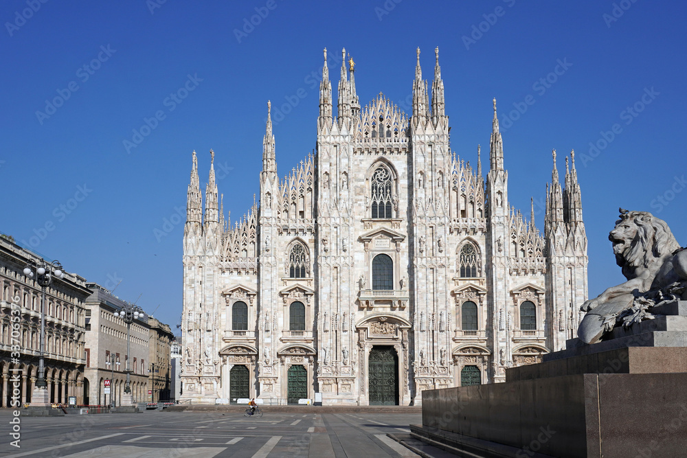 Milan, Italy - March 2020: empty square in Duomo cathedral downtown and Vittorio Emanuele gallery during   n-cov19 coronavirus quarantine. Pandemic. City of the desert. Piazza Duomo Empty streets