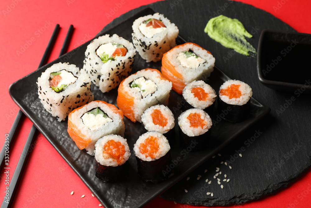 Delicious sushi rolls on red background. Japanese food Delicious sushi rolls on red background. Japanese food