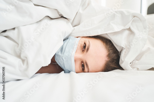 Girl infected with the novel coronavirus lying awake photo