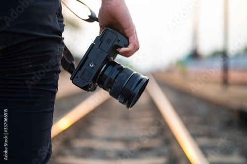 Photographer theme, Woman holding camera on hand while walking on train track