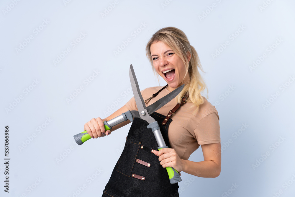 Blonde gardener woman over isolated background Blonde gardener woman over isolated background