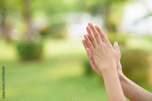 close up woman hands is applying alcohol sanitizer outdoor © tonefotografia