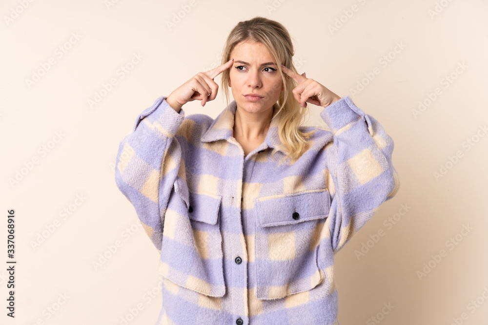 Blonde woman over isolated background having doubts and thinking Blonde woman over isolated background having doubts and thinking