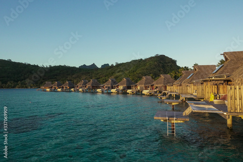 Photos Overwater Bungalows over Turquoise Lagoon with Reef at Sunset in Bora Bora Frenc