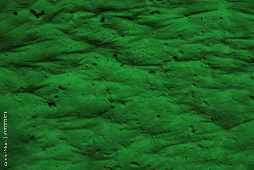 Saturated green surface with creases and swellings. Green background with creases.