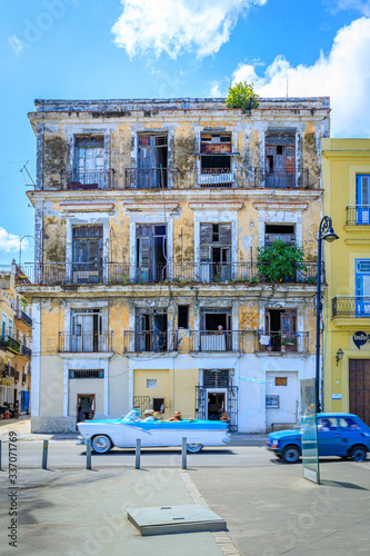 Havana Cuba Typical old classic vintage house with driving american car. 