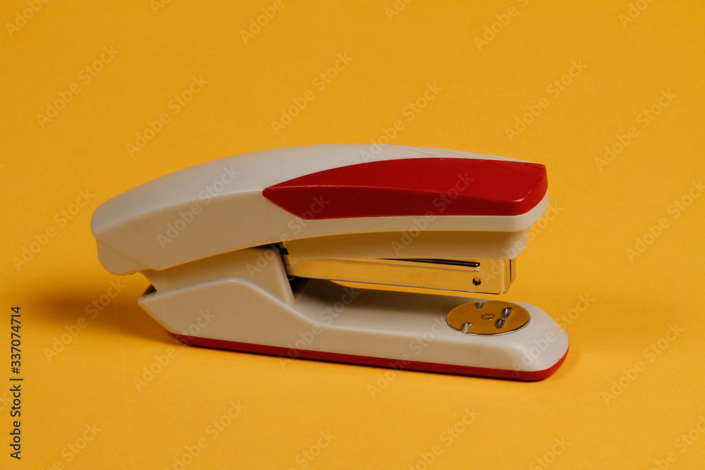 Wire stapler for office and desk in burgundy and gray. Wire stapler for office and desk in burgundy and gray.