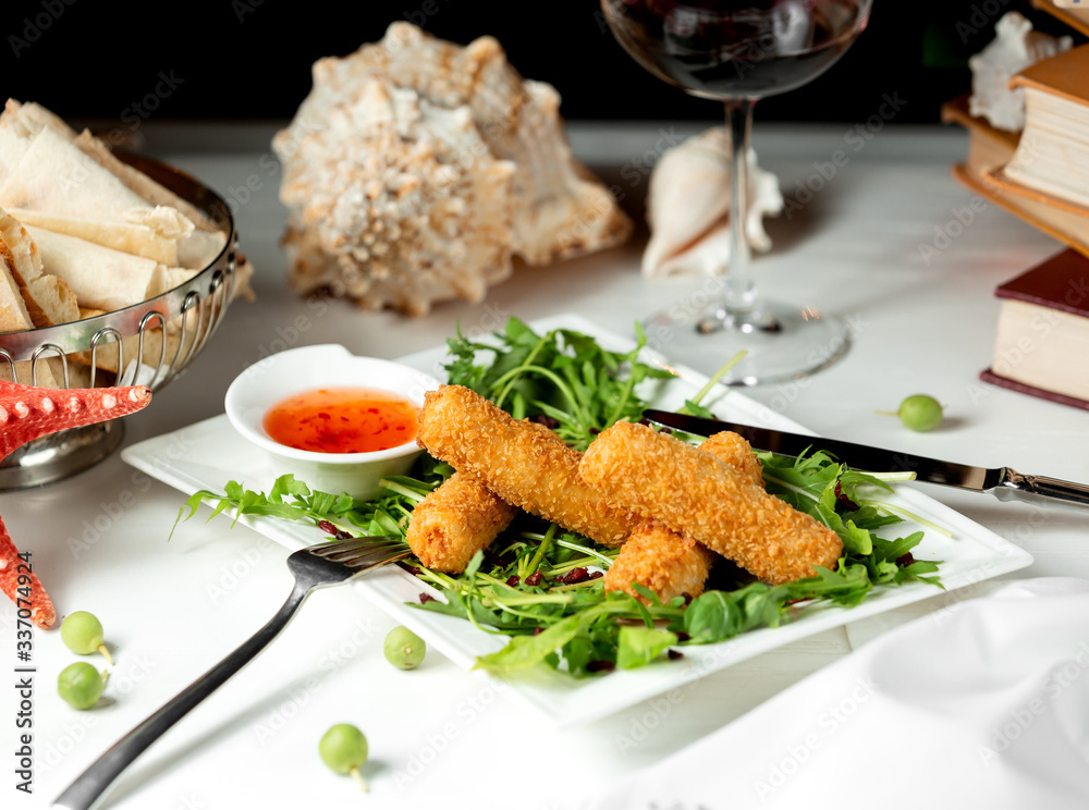 breaded crusty fingers served with green salad and sweet sauce