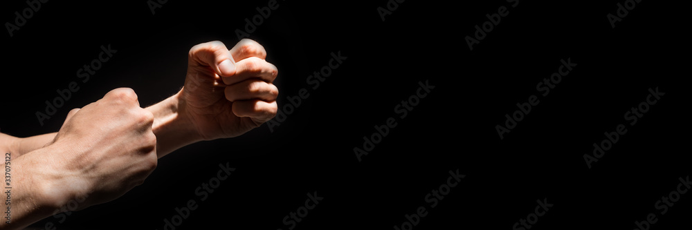 Two male fists isolated on black background.Headline.