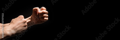 Two male fists isolated on black background.Headline.