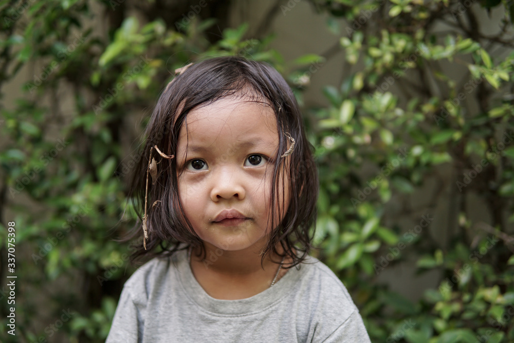 Cute young girls with dirty hair in the garden Cute young girls with dirty hair in the garden