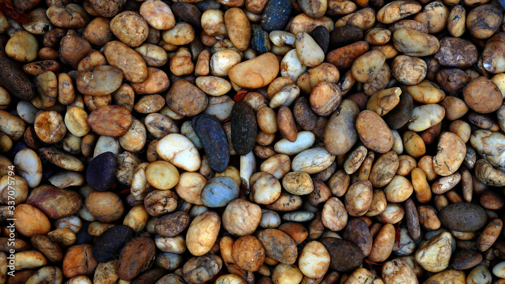 brown small stone background. pebble beach stone garden brown small stone background. pebble beach stone garden