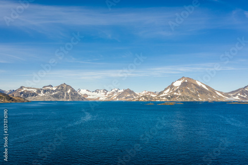 Glaciers and snow caps are seen off in the distance. 