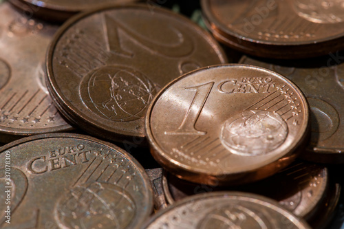 Concept of financial crisis in Europe. Euro coins close-up. 