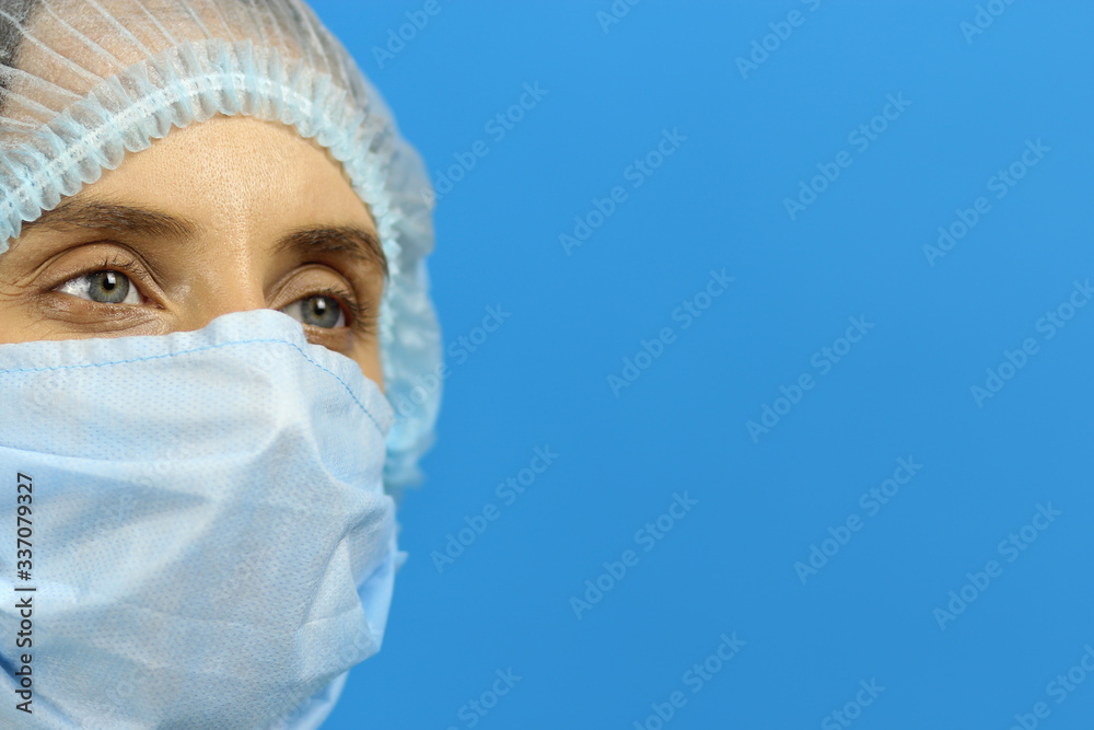 young woman doctor nurse in a coat and hat, a pensive, weary after the work shift, copy space for text young woman doctor nurse in a coat and hat, a pensive, weary after the work shift, copy space for text