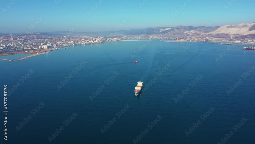 Aerial view of container ship floating with cargo from commercial sea port Aerial view of container ship floating with cargo from commercial sea port