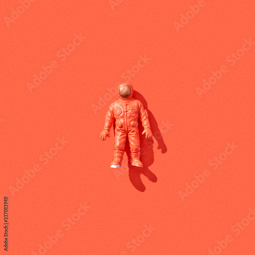 Plastic toy of spaceman with shadow.