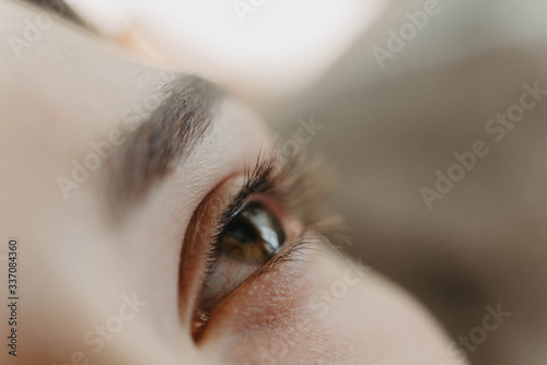 Process of a teenage girl having eyelash extensions put in photo