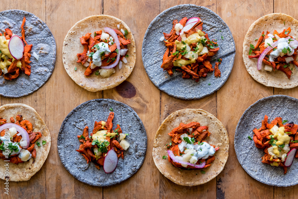 Tacos al pastor on wooden table Tacos al pastor on wooden table