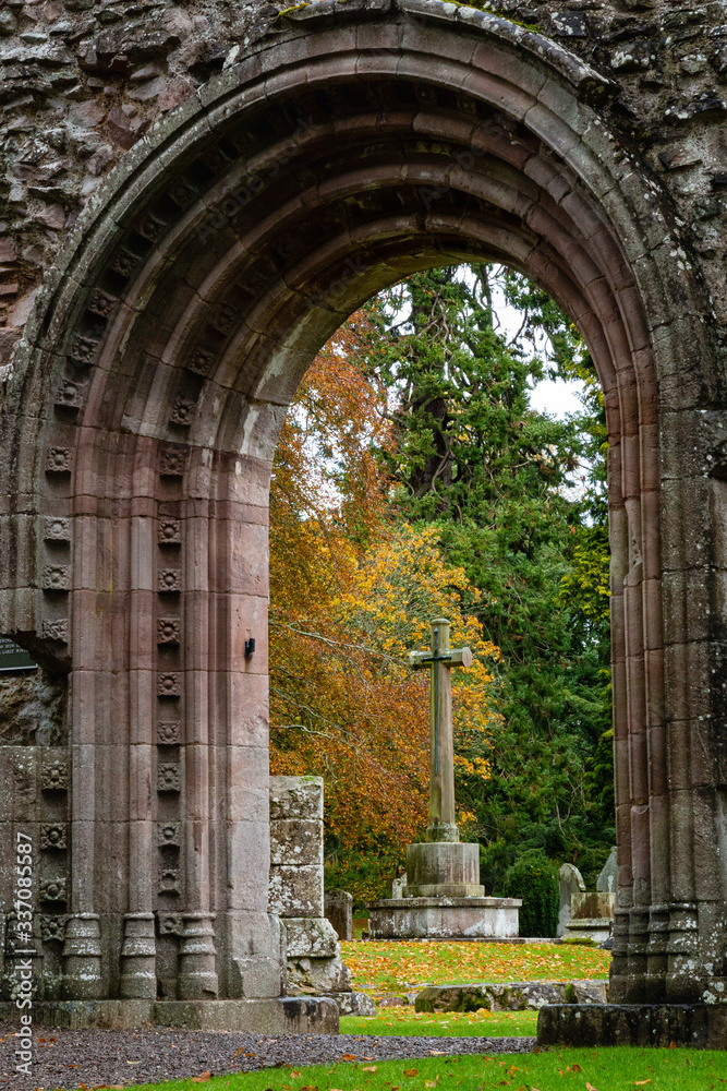 Moody soft light falls on Dryburgh Abbey ruins in the Borders area of Scotland, United Kingdom