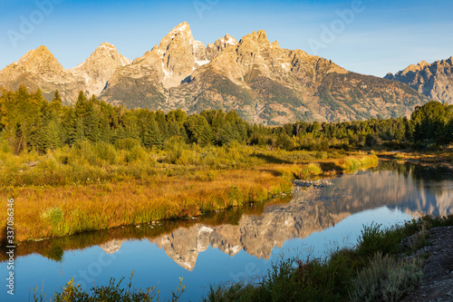 Teton mountain reflecting in water with Fall color © J Huser Photography