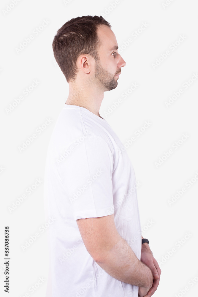Obraz premium Man stands sideways and looks straight ahead. Arms folded. White background