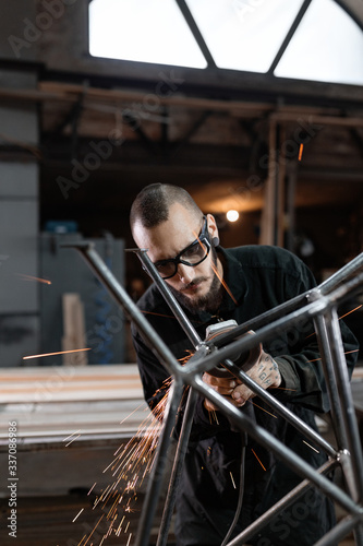 Contemporary man creating metal construction photo